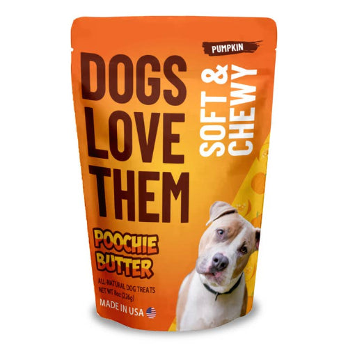 A stand-up pouch of 'Dogs Love Them' Soft & Chewy Poochie Butter dog treats in Pumpkin flavor. The packaging is bright orange with bold dark brown text, white text, and a photo of a white and tan pitbull-type dog on the front.