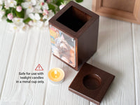 Thumbnail for A dark brown wooden memorial candle holder with a custom photo printed on the side, shown next to its matching wooden lid on a white wooden surface. A small tealight candle is placed in front, with a warning label indicating compatibility with tealight candles in a metal cup only.