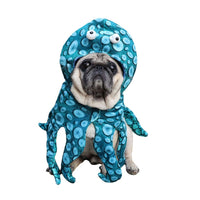 Thumbnail for A small pug dog wearing a blue octopus costume with light blue spots and googly eyes on the hood, photographed against a plain white background.