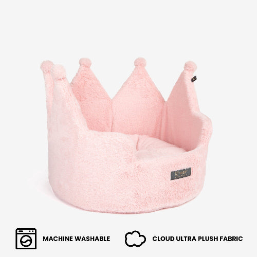 Pink crown-shaped pet bed with machine washable and cloud ultra plush fabric features on a white background.