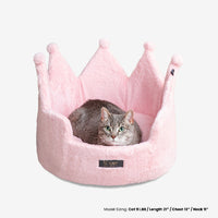 Thumbnail for Cat lying in a pink crown-shaped pet bed on a white background