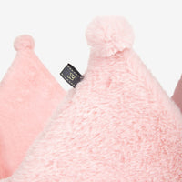 Thumbnail for Close-up of pink textured product with a brand label on a light gray background